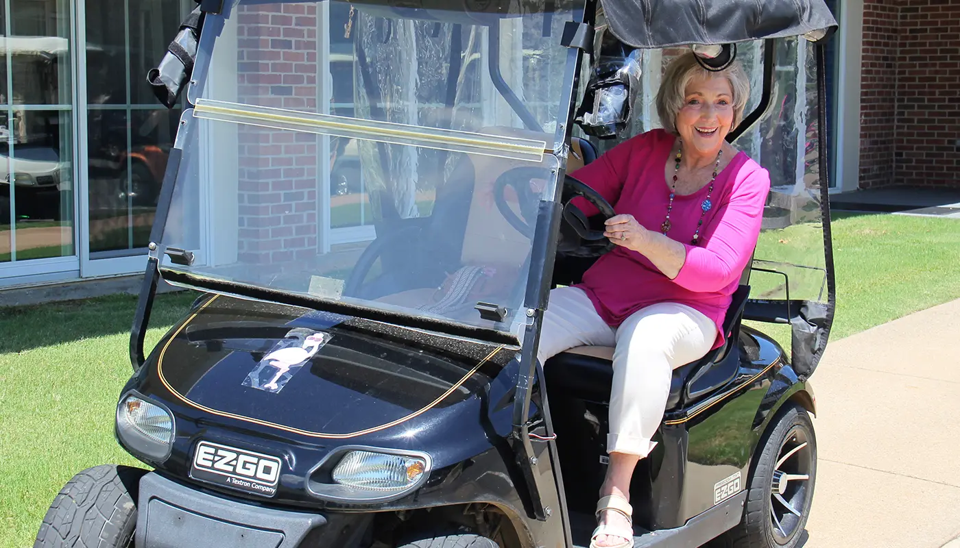 woman-leaning-out-of-golf-cart